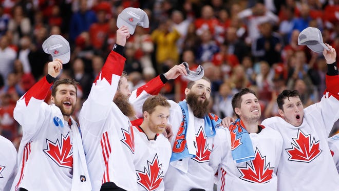 Team Canada players react during the playing of the national anthem after defeating Team Europe to win the World Cup of Hockey.