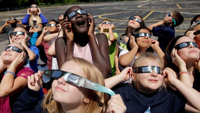 Fourth-graders at Clardy Elementary School in Kansas City, Mo., practice the proper use of their eclipse glasses on Aug. 18, 2017.