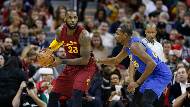 LeBron James is guarded by Kevin Durant at Quicken Loans Arena.