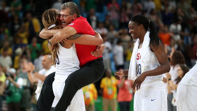 USA center Brittney Griner (15) celebrates with USA head coach Geno Auriemma (USA) in the women's basketball gold medal match during the Rio 2016 Summer Olympic Games at Carioca Arena 1.