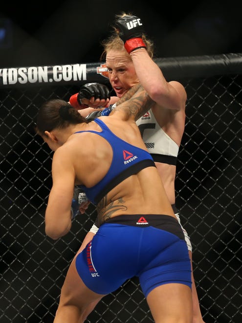 Holly Holm (red gloves fights Germaine de Randamie (blue gloves) during UFC 208 at Barclays Center.