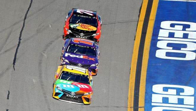 Kyle Busch (18), leads Denny Hamlin (11)  and Martin Truex Jr. (78)  during the first segment. Busch won the opening stage.