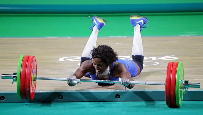 French weightlifter Gaelle Verlaine Nayo Ketchanke takes a spill during the 75-kilogram finals. Nayo Ketchanke finished eighth.