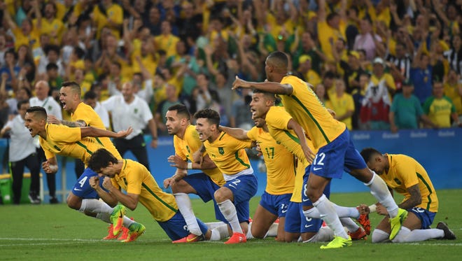 Brazil players celebrate after defeating Germany in the men's gold medal match during the Rio 2016 Summer Olympic Games at Maracana.