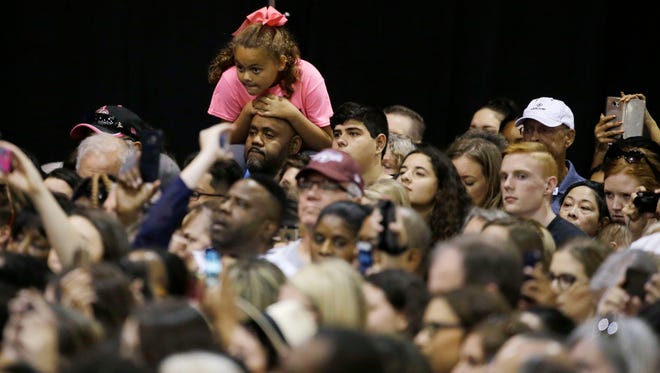 Supporters listen to first lady Michelle Obama address the Arizona Democratic Party Early Vote rally at the Phoenix Convention Center on Thursday, Oct. 20, 2016.  Obama is campaigning for Democratic presidential nominee Hillary Clinton.