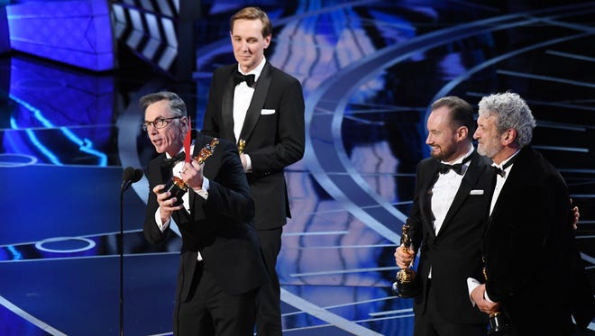 Kevin O'Connell accepts the award for Achievement in sound mixing for 'Hacksaw Ridge' along with Robert Mackenzie, Andy Wright, and Peter Grace during the 89th Academy Awards.