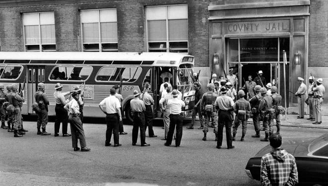 People leave the Wayne County jail in downtown Detroit board a bus during the riots in Detroit in1967.