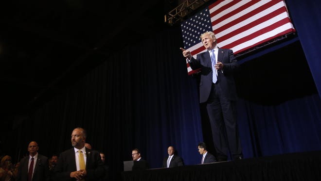 Republican presidential candidate Donald Trump walks on stage before speaking to a crowd at the Phoenix Convention Center in Arizona August 31, 2016.