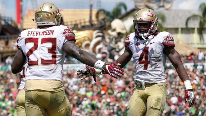 Florida State Seminoles running back Dalvin Cook (4) and fullback Freddie Stevenson (23) celebrate after a touchdown in the second quarter against the South Florida Bulls at Raymond James Stadium.