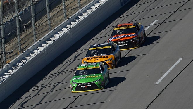 (From front to back) Joe Gibbs Racing teammates Carl Edwards, Matt Kenseth and Kyle Busch purposely trailed the field for most of the day at Talladega Superspeedway.