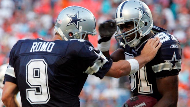 Romo celebrates a touchdown with Terrell Owens in 2007.
