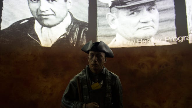 Photos of Native American soldiers throughout history are seen behind a figure depicting 'Grasshopper' inside the upcoming Museum of the American Revolution Friday, March 24 in Philadelphia.