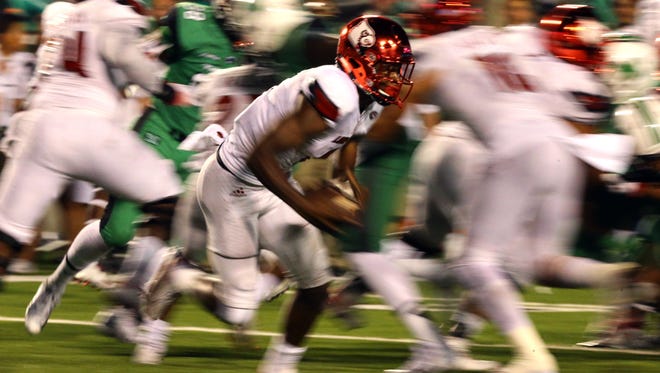 Louisville Cardinals quarterback Lamar Jackson (8) carries the ball against the Marshall Thundering Herd in the second half at Joan C. Edwards Stadium. The Louisville Cardinals won 59-28.