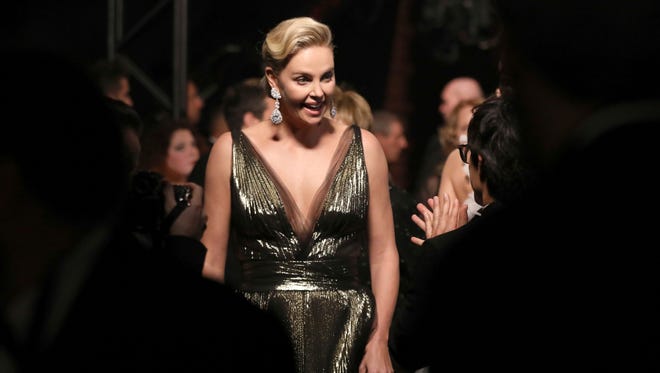 Charlize Theron appears backstage at the Oscars in Los Angeles.