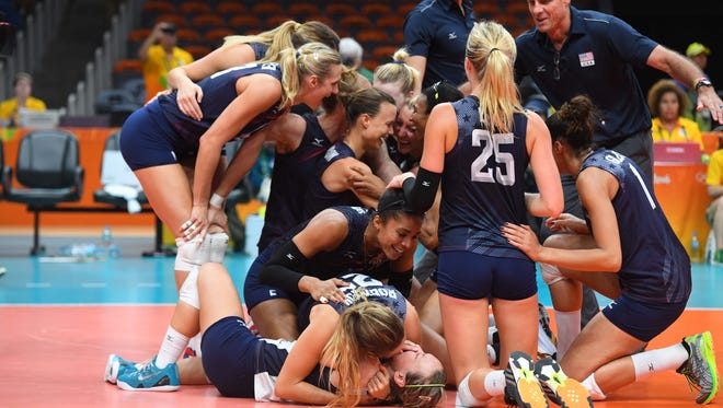 USA players celebrate after defeating the Netherlands in the women's volleyball bronze medal match in the Rio 2016 Summer Olympic Games at Maracanazinho.