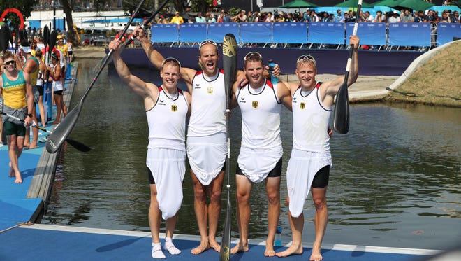Germany team members Max Rendschmidt , Tom Liebscher, Max Hoff and Marcus Gross celebrate after winning the men's kayak four 1000m final during the Rio 2016 Summer Olympic Games at Lagoa Stadium.