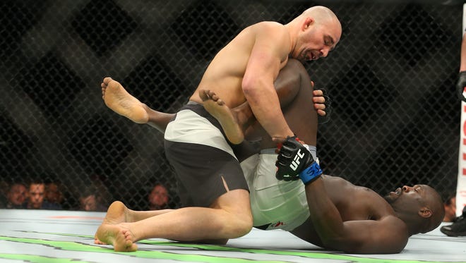 Glover Teixeira (red gloves) fights Jared Cannonier (blue gloves) during UFC 208 at Barclays Center.
