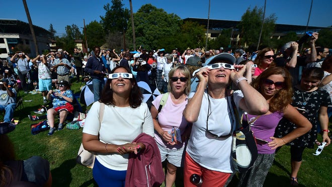 People use solar eclipse glasses to view the solar eclipse from Beckman Lawn at Caltech in Pasadena, California on August 21, 2017.
Emotional sky-gazers on the US West Coast cheered and applauded Monday as the Sun briefly vanished behind the Moon -- a rare total solar eclipse that will stretch across North America for the first time in nearly a century. / AFP PHOTO / FREDERIC J. BROWNFREDERIC J. BROWN/AFP/Getty Images ORIG FILE ID: AFP_RQ5ZZ