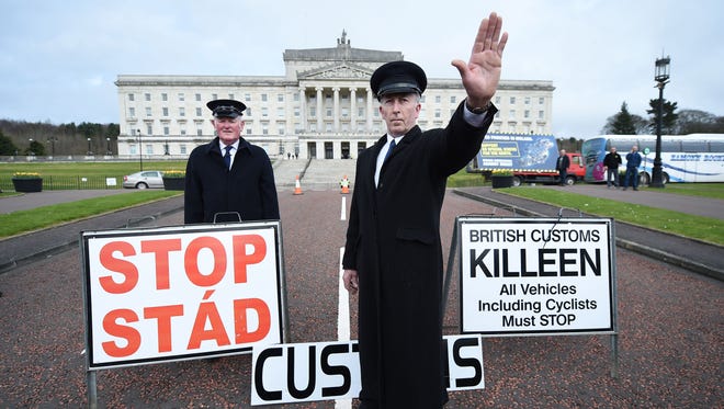 Two men dressed as customs officers take part in a protest outside Stormont against Brexit and its possible effect on the north and south Irish border on March 29, 2017, in Belfast, Northern Ireland.