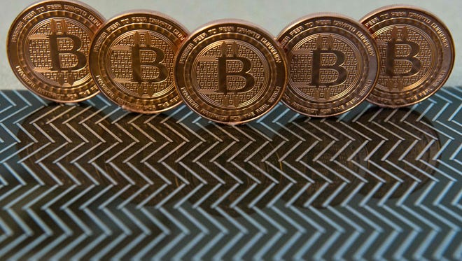 File photo taken in 2014 shows medals of digital currency called bitcoins.