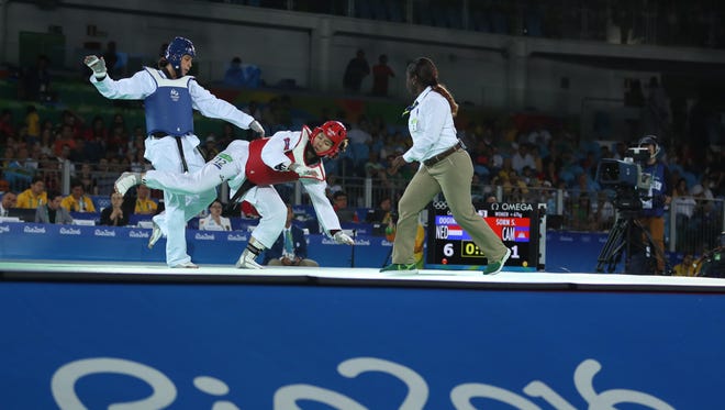 Reshmie Shari Oogink of the Netherlands  competes against Seavmey Sorn of Cameroon in a women's taekwondo +67kg round of 16 taekwondo match during the Rio 2016 Summer Olympic Games at Carioca Arena 3.