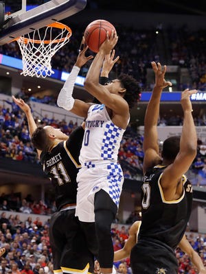 Kentucky Wildcats guard De'Aaron Fox (0) shoots against Wichita State Shockers guard Landry Shamet (11) during the second half in the second round of the 2017 NCAA Tournament at Bankers Life Fieldhouse.