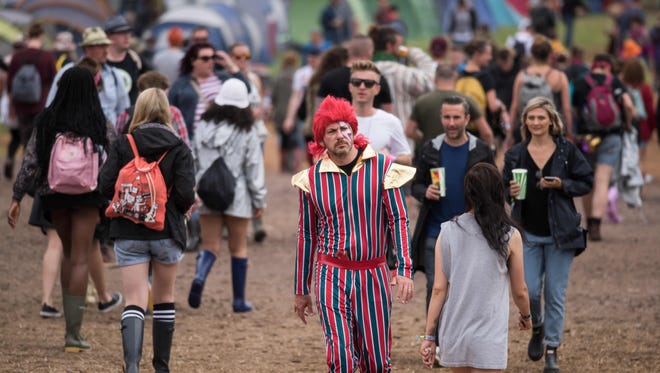 Attendees are on the move at the Glastonbury Festival of Music and Performing Arts in Somerset, England, this weekend. Click forward to see famous faces who are there.