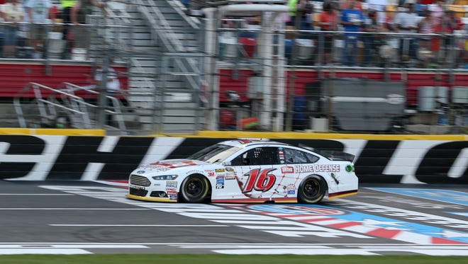 Greg Biffle crosses the finish line to win the first leg of the 2015 Sprint Showdown at Charlotte Motor Speedway to advance to the Sprint All-Star Race.