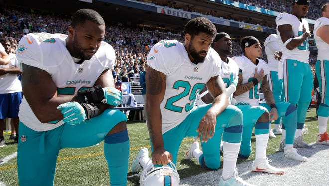 Dolphins players, from left, Jelani Jenkins, Arian Foster, Michael Thomas and Kenny Stills knelt during the anthem at the opener against the Seahawks.