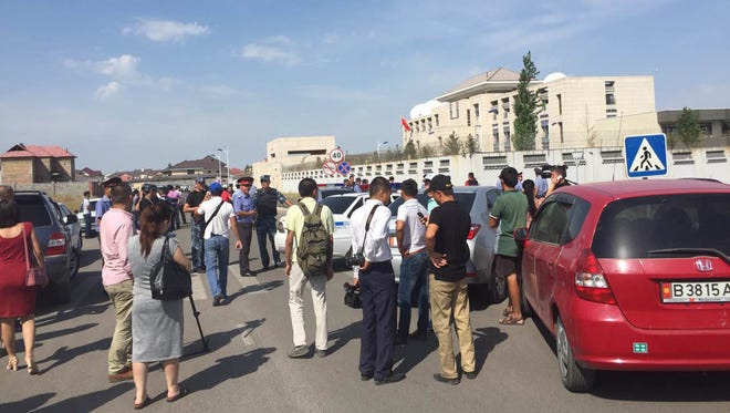 In this photo released by China's Xinhua News Agency, people gather near the site of an explosion in Bishkek, Kyrgyzstan, Tuesday, Aug. 30, 2016.