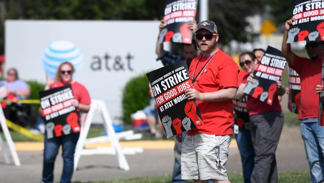 AT&T workers demonstrate along Vogel Road in Evansville, Friday, May 19, 2017.