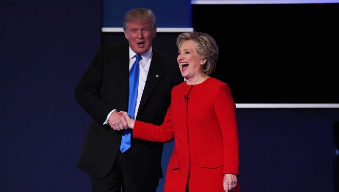 Democratic presidential candidate Hillary Clinton shakes hands with Republican presidential candidate Donald Trump on stage at the conclusion of the first presidential debate at Hofstra University.