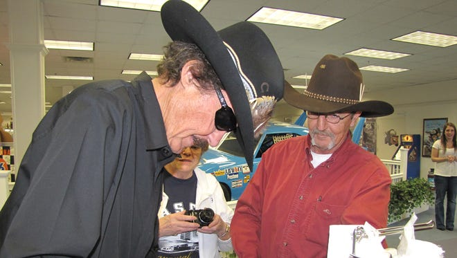 Richard Petty autographs merchandise at his museum/store in Randleman, N.C. Petty also runs the  nearby NASCAR-themed Victory Junction Gang Camp, which has hosted thousands of sick and disabled children since opening in 2004.
