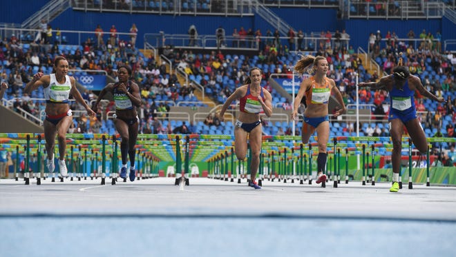 Competitiors finish their  100-meter hurdles heat of the women's heptathlon at Estadio Olimpico Joao Havelange during the 2016 Rio Summer Olympic Games.