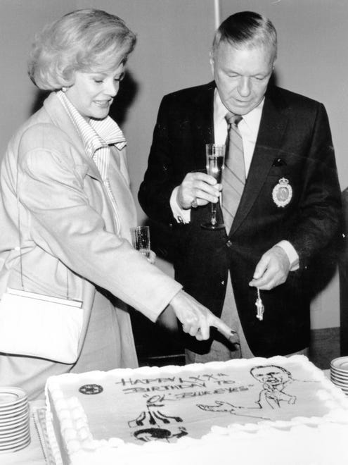 Barbara Sinatra presents her husband with a 70th birthday cake at a groundbreaking ceremony for the Barbara Sinatra Children's Center in 1985.