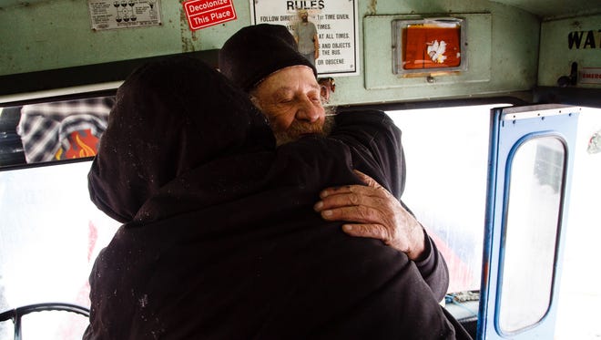 Bus driver Bill Hill from New York, hugs Fronz after giving him the supplies he needed to fix his solar panel in the Oceti Sakowin Camp on Monday, Dec. 5, 2016, near Cannon Ball.
