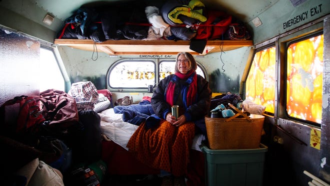 Denise O'Brien, from Atlantic, Iowa, poses for a photo in the back of their converted school bus in the Oceti Sakowin Camp on Monday, Dec. 5, 2016 near Cannon Ball. The bus started life as a school bus in the 80s then was used as a RAGBRAI bus as recently as this past year.