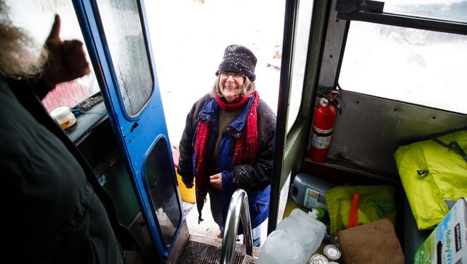 Denise O'Brien, from Atlantic, Iowa, gets a thumbs up from bus driver Bill Hill of New York as she transfers supplies onto the bus in the Oceti Sakowin Camp on Monday, Dec. 5, 2016, near Cannon Ball. The bus started life as a school bus in the 80s then was used as a RAGBRAI bus as recently as this past year.