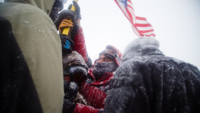 Veterans return to camp after marching to the highway 1806 bridge north of the Oceti Sakowin Camp on Monday, Dec. 5, 2016 near Cannon Ball. Officials had been staffing the bridge full time but have said they are going to cut back.