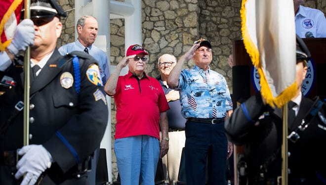 George Hardy, a Tuskegee Airman, center left, and Vernon "Bo" Sigo, an Army Air Force B-17 Navigator, center right, salute the flag during a special reunion for the two veterans at Cambier Park on Tuesday, May 9, 2017, in Naples, Fla. It was Sigo's lifelong dream to personally thank a Tuskegee Airman for keeping him safe while escorting him and his crew on their missions  during World War II.
