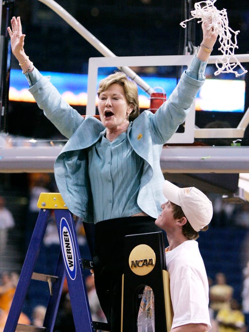 Summitt waves to the fans as her son Tyler holds the national championship trophy after the Lady Vols defeated Stanford 64-48 in the 2008 NCAA tournament final in Tampa, Fla.