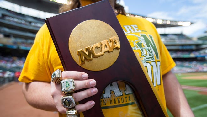 A members of North Dakota State shows off his rings and the championship trophy in June.
