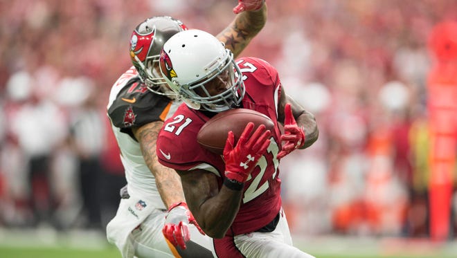 Cardinals defender Patrick Peterson (21) hauls in a first-half interception intended for Buccaneers receiver Mike Evans (13).