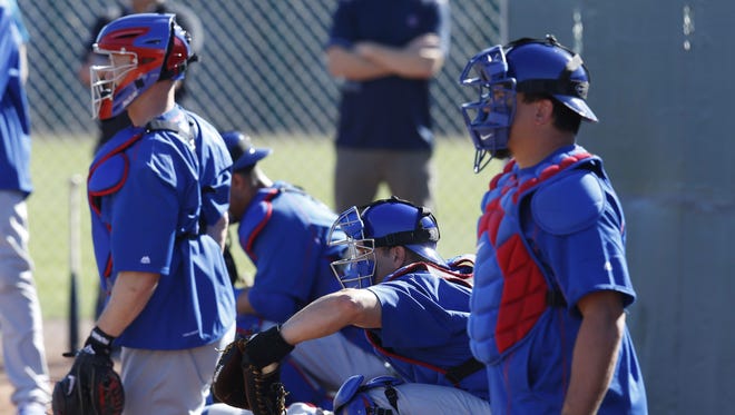Chicago Cubs catchers work out in the bullpen during spring training 2016 in Mesa, Ariz.