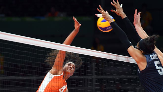 Rachel Adams of the United States blocks a spike from Celeste Plak of the Netherlands in the women's volleyball bronze medal match during the Rio 2016 Summer Olympic Games at Maracanazinho.