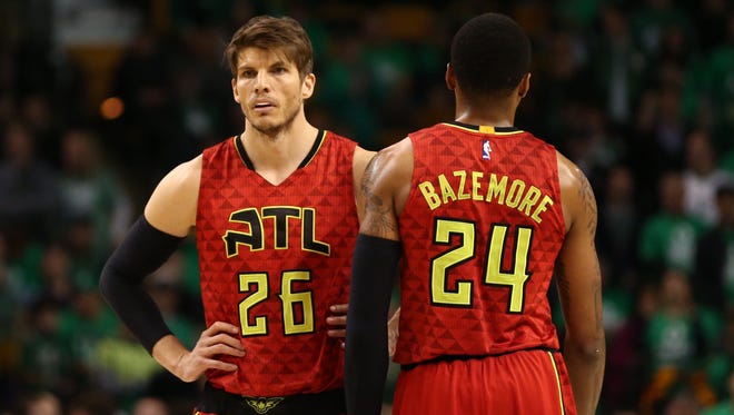 Kyle Korver and Kent Bazemore look on against the Boston Celtics during the second half in game six of the first round of the NBA Playoffs at TD Garden.