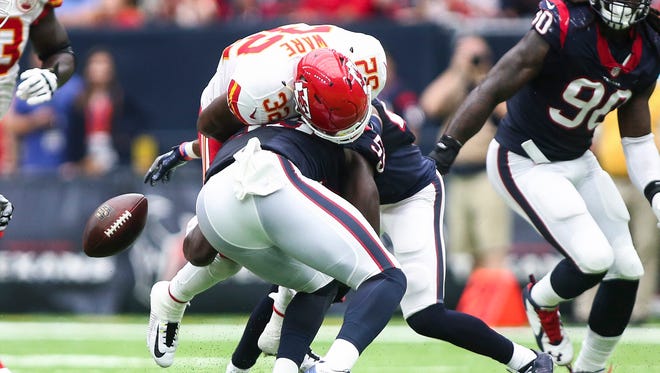 Chiefs running back Spencer Ware (32) fumbles the ball after a hit by Texans defender Whitney Mercilus (59) during the first half.