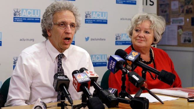 In this June 30, 2016, file photo, Ken Faulk, left, legal director of the American Civil Liberties Union of Indiana, with Betty Cockrum, president of Planned Parenthood of Indiana and Kentucky, speaks during a news conference in Indianapolis. On Wednesday, June 28, 2017, a federal judge issued a preliminary injunction against Indiana's abortion law that would make it more difficult for girls under 18 to get an abortion without their parents' knowledge and consent.