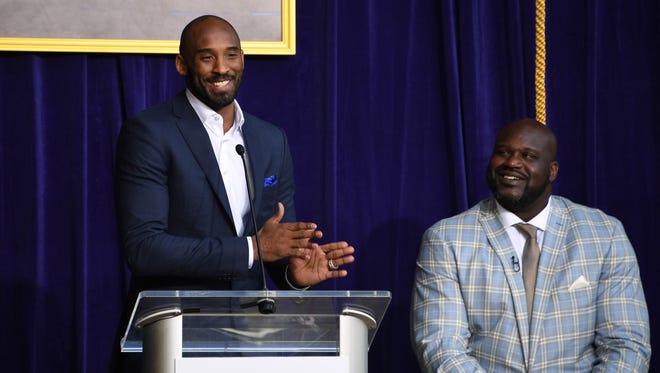 Kobe Bryant (left) speaks during ceremony to unveil statue of Los Angeles Lakers former center Shaquille O'Neal at Staples Center.
