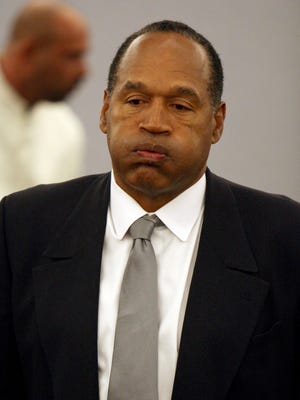 O.J. Simpson arrives in court in the 2008 trial in which he was found guilty on 12 counts and sentenced to nine years minimum and 33 years maximum.